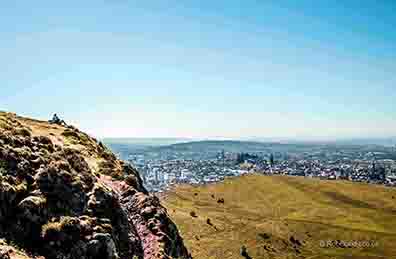 <p>A couple relax apon Arthur's Seat looking down on edinbugh</p>